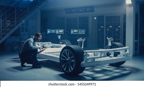 Automobile Engineer Work On Electric Car Platform Chassis Prototype, Using Tablet Computer With 3D CAD Software Modelling. Innovative Facility: Vehicle Frame With Wheels, Engine,Battery And Suspension