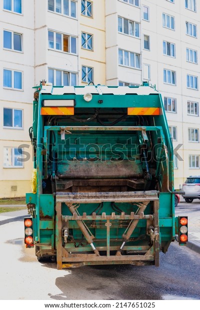 An automobile garbage truck collects garbage in\
residential areas of a modern city. Close-up of a car for\
collecting and transporting\
garbage