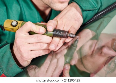 Automobile Glazier Repairman At Windscreen Repair Of A Car In Auto Service Station Garage