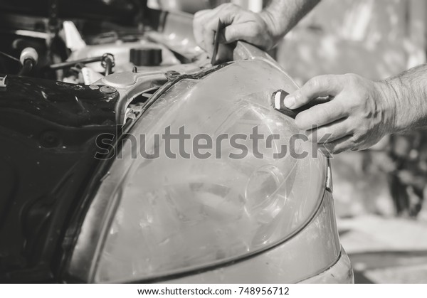 Automobile industry.\
Close up on car detail - male hand polish in auto repair shop\
background. Professional person during mechanical maintenance,\
industrial part transport\
renovation