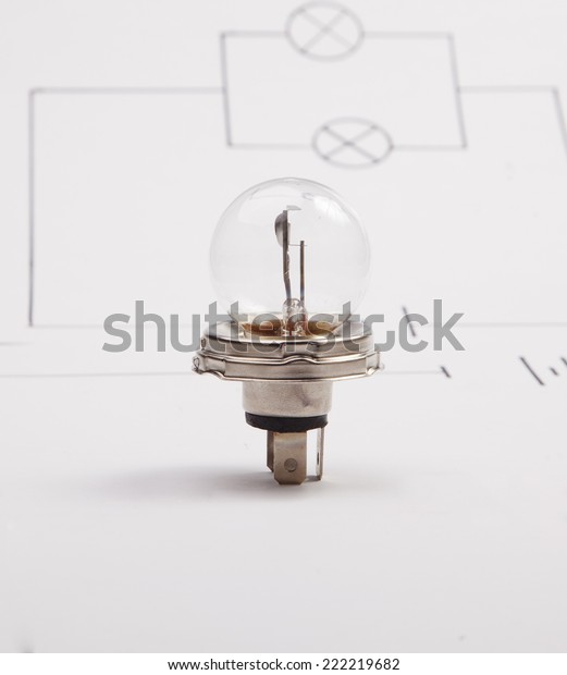 Automobile\
lamp on a background of the electric\
scheme