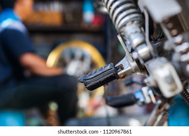 Automobile mechanic repairing motorcycle in bike repair shop - Shutterstock ID 1120967861