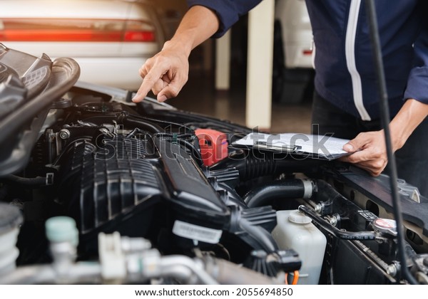 Automobile mechanic repairman hands repairing a\
car engine automotive workshop with a wrench, car service and\
maintenance,Repair\
service.