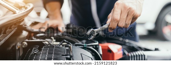 Automobile mechanic repairman hands repairing a
car engine automotive workshop with a wrench, car service and
maintenance,Repair
service.