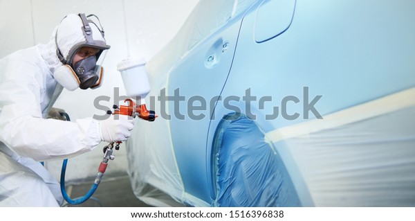 automobile
painting. car painter with gun in
chamber