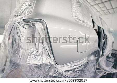 Automobile in paint-spraying booth of repair workshop