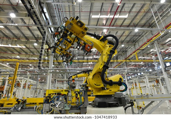 Automobile plant, Industrial machinery automatic\
arm welding cars robot in production line of vehicle manufacturer\
factory