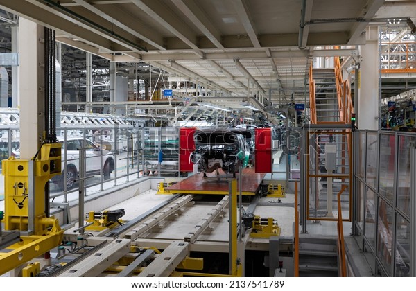 Automobile production line. Modern\
car assembly plant. Interior of a high-tech factory,\
manufacturing