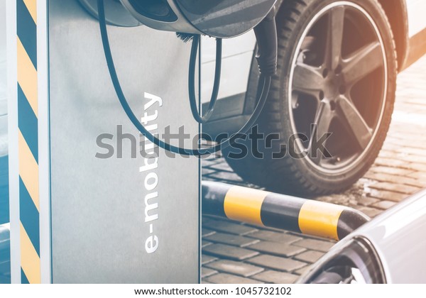 Automobile refueling for electric cars e-mobility\
in the background car,\
wheel.
