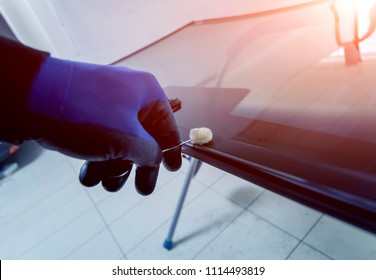 Automobile Special Workers Replacing Windscreen Or Windshield Of A Car In Auto Service Station Garage. Background