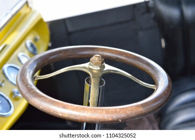 Automobile: Steering wheel of antique roadster.
