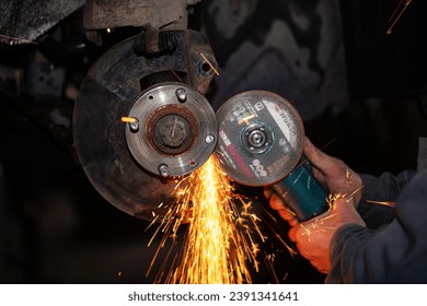 automobile wheel repair using angle grinder in car service - Powered by Shutterstock