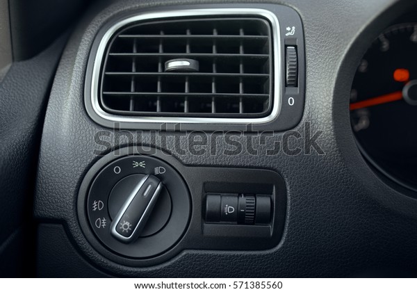 Automotive air\
conditioning. The flow of air inside the vehicle. headlamp switch.\
Detail of the interior of the\
car