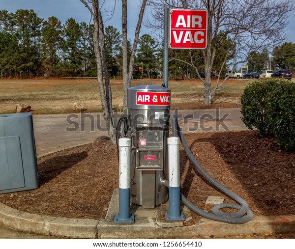 Automotive air pump and vacuum machine. Gas service\
station coin operated tire inflation and car vacuum machine with\
red Air Vac sign.