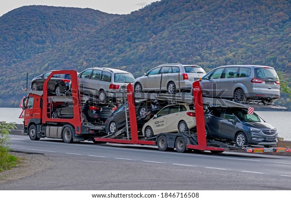 An\
automotive car carrier truck driving down the highway with a full\
load of new vehicles. Big car carrier trailer with cars on bunk\
platform. Romania, Orsova. November, 02,\
2020