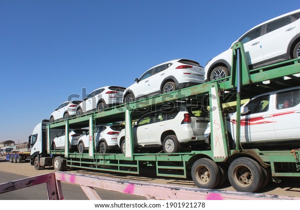 An automotive car carrier truck driving down the\
highway with a full load of new vehicles - Khartoum - Khartoum\
North Sudan 25 January 2021
