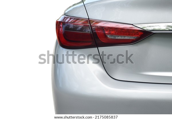 Automotive close up of silver car lamp\
taillight, bumper, rear trunk lid\
exterior