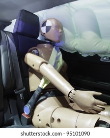 Automotive crash test dummy strapped into car seat, head against air bag - Shutterstock ID 95101090