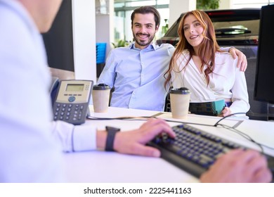 Automotive dealership sales representative advising clients in company office - Shutterstock ID 2225441163