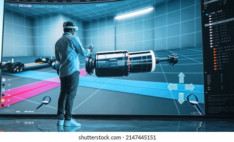 Automotive Engineer Making Presentation of a Modern VR Software Testing and Developing Vehicle Platforms. Engineer Uses Headset and Controllers to Showcase Functionality on a Big Screen on Stage. - Powered by Shutterstock