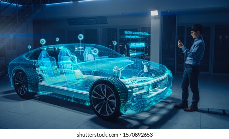 Automotive Engineer Using Digital Tablet Computer with Augmented Reality 3D Software for 3D Car Model Design Analysis and Improvement. Futuristic Facility: Virtual Design with Mixed Technology. - Powered by Shutterstock