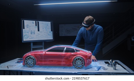 Automotive Engineer Wearing Virtual Reality Headset Working On 3D Electric Car Design, Using Gestures In Augmented Reality And Designs And Manipulates Graphical Parts, Picks Body For Chassis, Engine