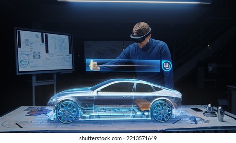 Automotive Engineer Wearing VR Headset Working on 3D Electric Car Prototype, Using Gestures in Augmented Reality. Manipulates Graphical Parts, Picks Body for the Chassis and Engine - Powered by Shutterstock