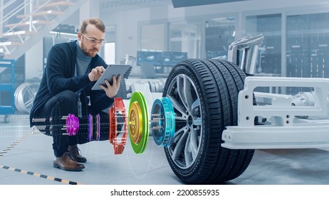 Automotive Engineer Working On Electric Car Chassis, Using Augmented Reality Headset With 3D VFX Application For Development Of Regenerative Braking System On A Futuristic Concept Transport Vehicle.