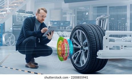 Automotive Engineer Working On Electric Car Chassis, Using Augmented Reality Headset With 3D VFX Application For Development Of Regenerative Braking System On A Concept Transport Vehicle.