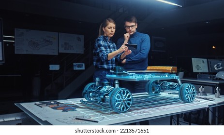 Automotive Engineers Working On 3D Electric Car Design Through Smartphone AR Software, Using Gestures In Augmented Reality. Designing Graphical Parts, Picks Body And Color For The Chassis, Engine