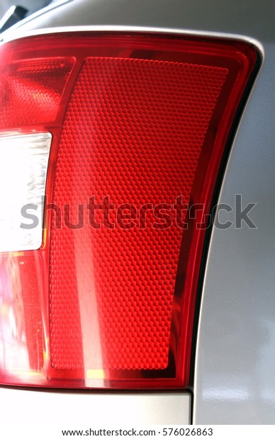 Automotive industry\
parts, family car taillight design, red light rear body car with\
light reflections brake and reverse gear lamps, euro rear look red\
light of modern grey car\
