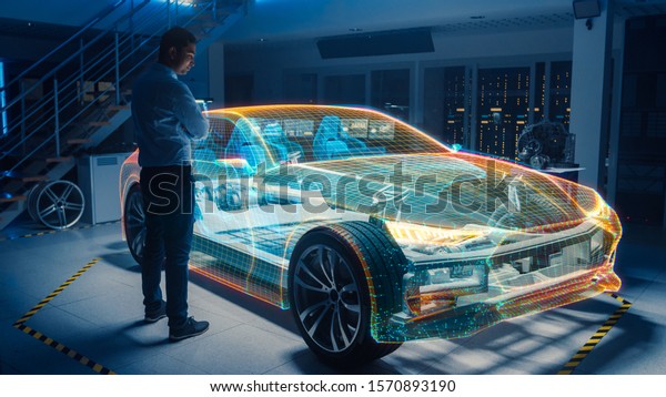 In
Automotive Innovation Facility Automobile Design Engineer Working
on 3D Holographic Model Projection of Electric Car. Futuristic
Concept of Virtual and Augmented Realty
Use.
