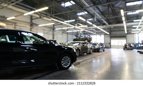 Automotive Locksmith Workshop At An Authorized Dealer With Cars Awaiting And Repairing, Blurred Photo With Depth Of Field