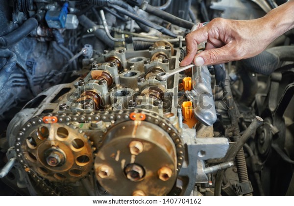 Automotive mechanic checking the auto engine. The\
powerful engine of a car.\
