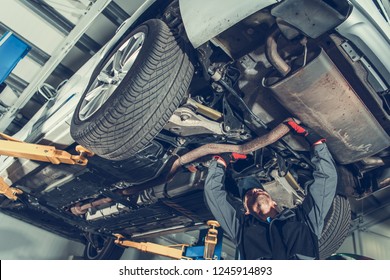 Automotive Mechanic Job. Caucasian Auto Service Worker And The Vehicle Maintenance.
