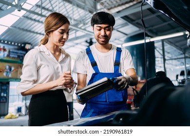 Automotive Mechanic Repairman Talking To Female Customer At The Garage, Check The Mileage Of The Car, Oil Change, Auto Repair Service Concept.