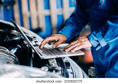 Automotive mechanic repairman using laptop computer and checking engine in the engine room, check the mileage of the car, oil change, auto maintenance service concept - Powered by Shutterstock