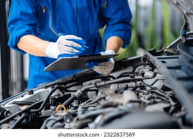 Automotive mechanic repairmen checking the system working engine of the engine room, check the mileage of the car, oil change, auto maintenance service concept.