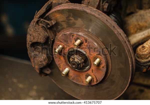 Automotive mechanical industry\
concept. Disc brakes in workshop. Disassembled car parts in\
garage.