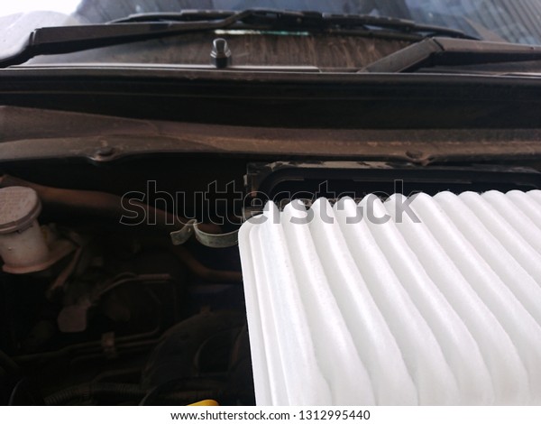 Automotive new engine air filter in the engine room\
with more dust