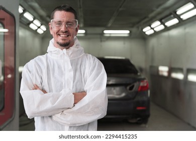 Automotive paint services and quality auto body shop concept. Male car mechanic working and standing with crossed arm in automotive paint service shop with happy and smile - Powered by Shutterstock