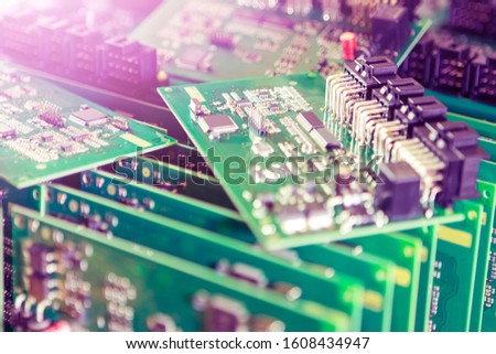 Automotive Printed Circuit Boards with Surface Mounted Components with PCBs On Top of Boards. Lens Flares Added. Horizontal Image Composition