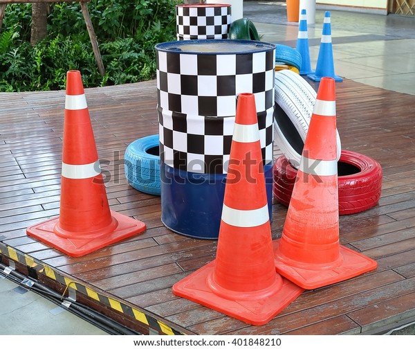 Automotive Safety Concepts, Painted\
Tires with Orange Traffic Cones and Traffic\
Barrels.