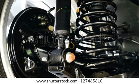 Automotive shock absorbers and springs installed in cars.