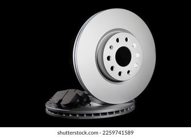 Automotive spare parts from the braking system. Brake pads and discs on a black background - Shutterstock ID 2259741589