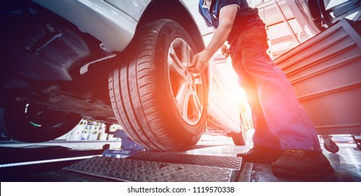 Automotive suspension test and brake test rolls in a auto repair service. Background - Shutterstock ID 1119570338