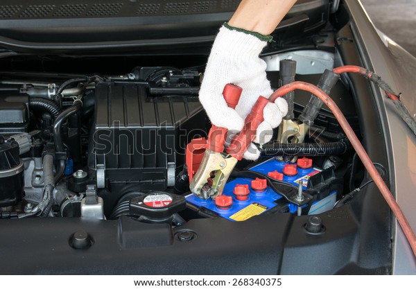 automotive technician\
charging vehicle\
battery