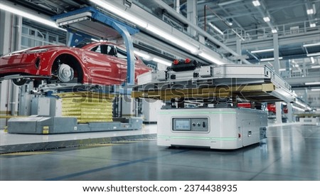 Autonomous AGV Transports Batteries on EV Production Line on Advanced Bright Smart Factory. Performance Electric Car Manufacturing. Car Batteries being Attached to Electric Vehicles on Assembly line