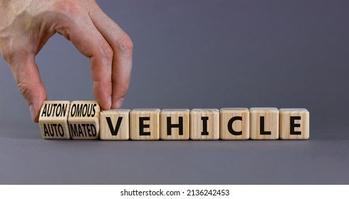 Autonomous Or Automated Vehicle Symbol. Businessman Turn Cubes And Changes Words Automated Vehicle To Autonomous Vehicle. Grey Background. Business Autonomous Or Automated Vehicle Concept, Copy Space.