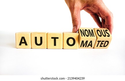 Autonomous Or Automated Vehicle Symbol. Businessman Turns Cubes And Changes Words Autonomous To Automated. White Background. Business Technology Autonomous Or Automated Vehicle Concept. Copy Space.